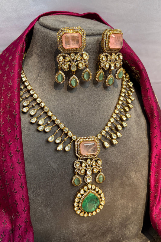 Ornate necklace and earrings set on a mannequin with a pink dupatta