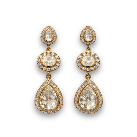 Gold teardrop earrings with clear gemstones on a white background